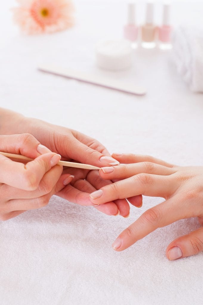 Nail pampering. Close-up of manicure master preparing customers nails for manicure
